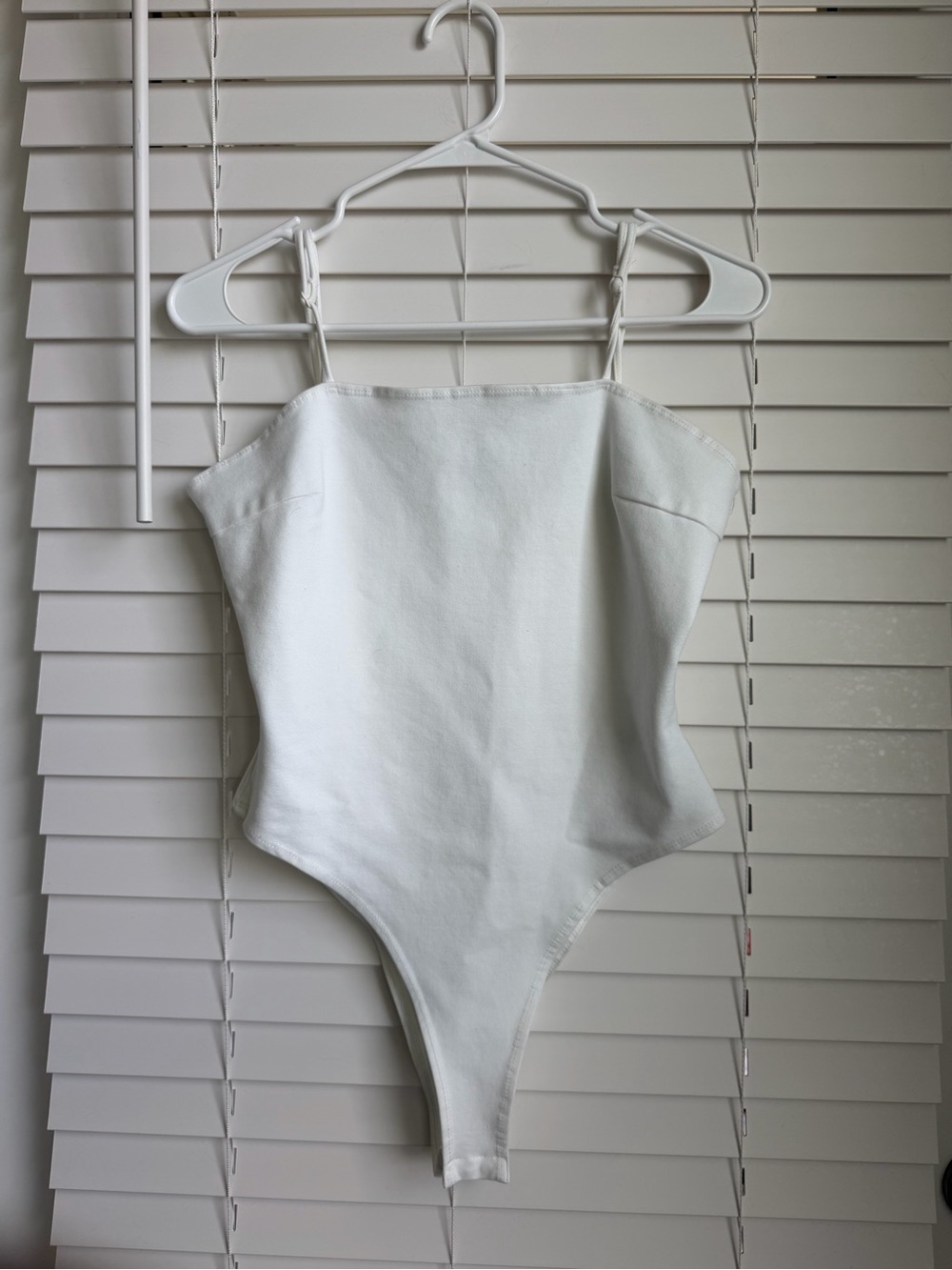 Chic White Spaghetti-Strap Bodysuit with Adjustable Straps